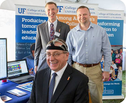 UF President Kent Fuchs is trying on our EEG headset